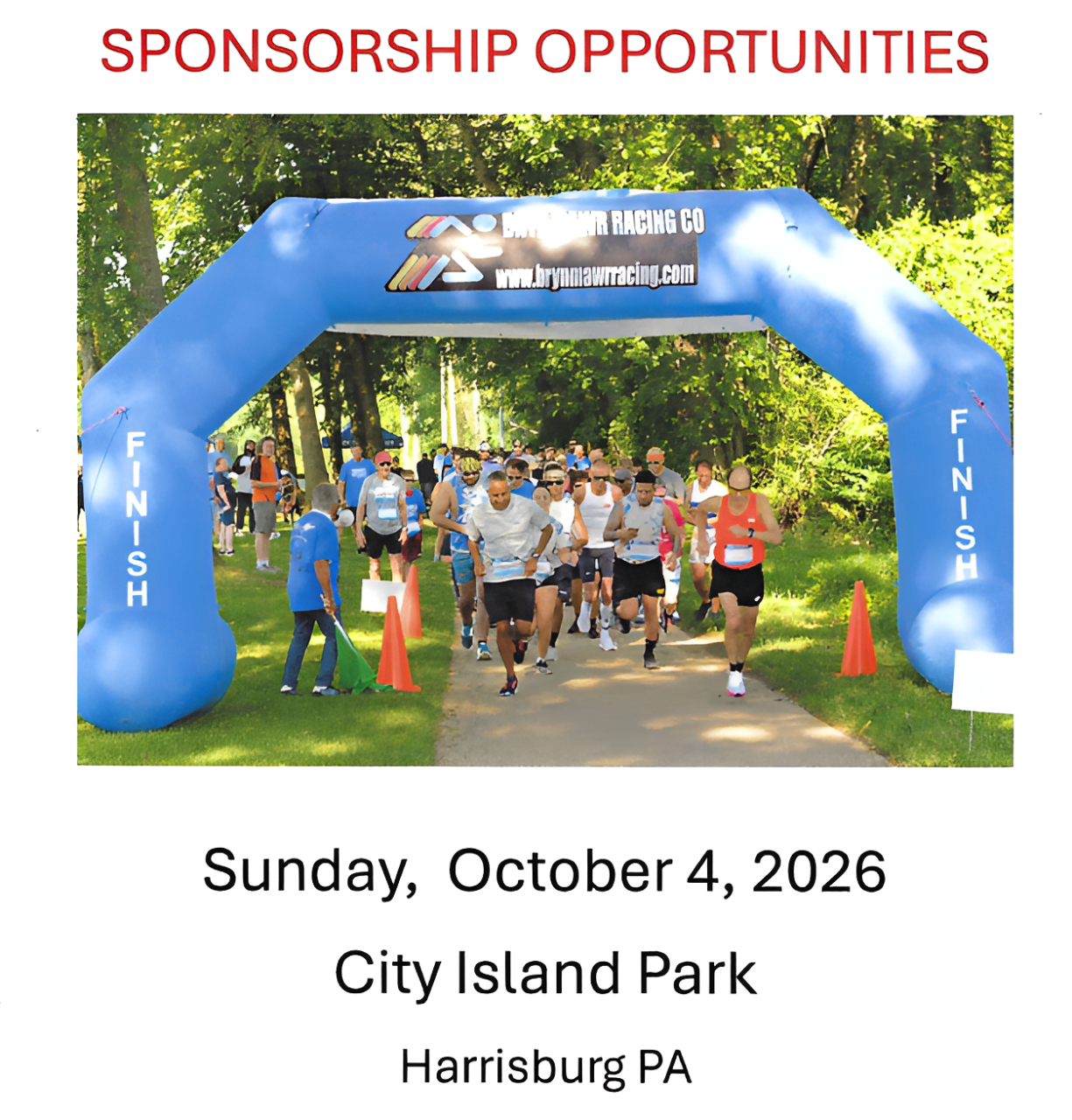 Runners starting race under inflatable arch.