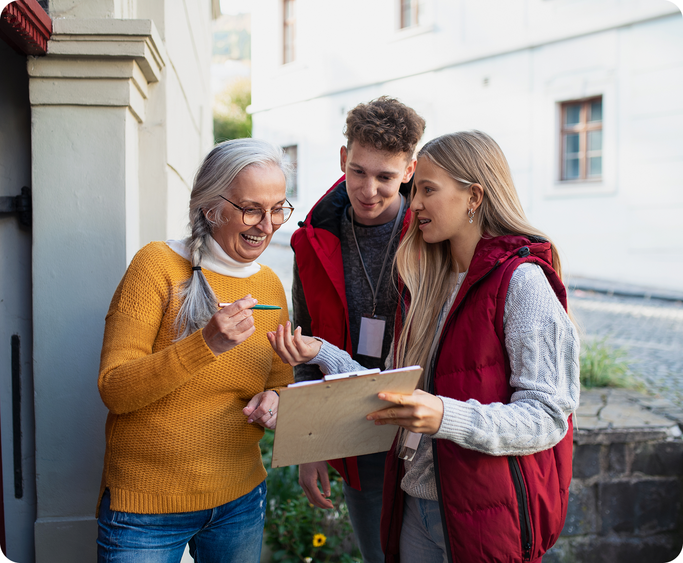 Older woman and two young adults smiling.