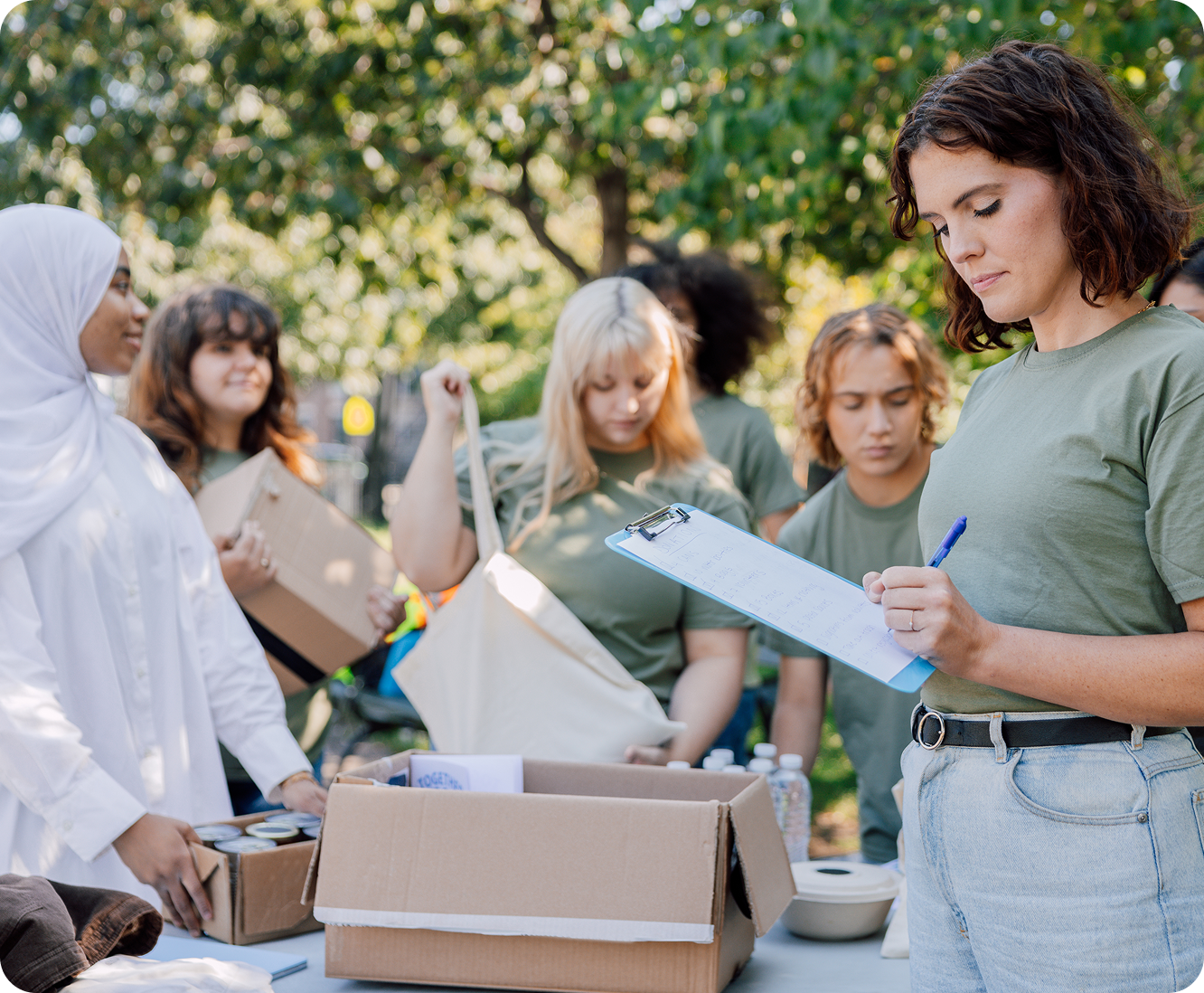 Volunteers organizing donations outdoors at table.